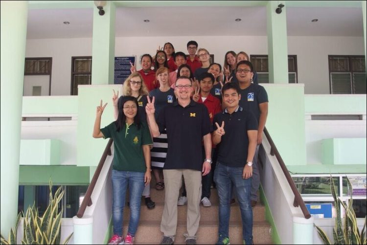 Members of the Exposure Research Lab pose on the front steps of a building, with professor Rick Neitzel in the center.
