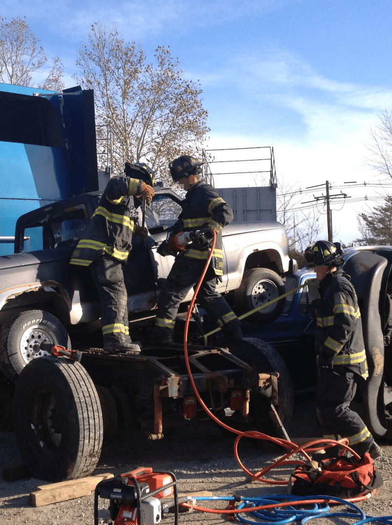 Firefighters take part in a training scenario involving a vehicle crash.